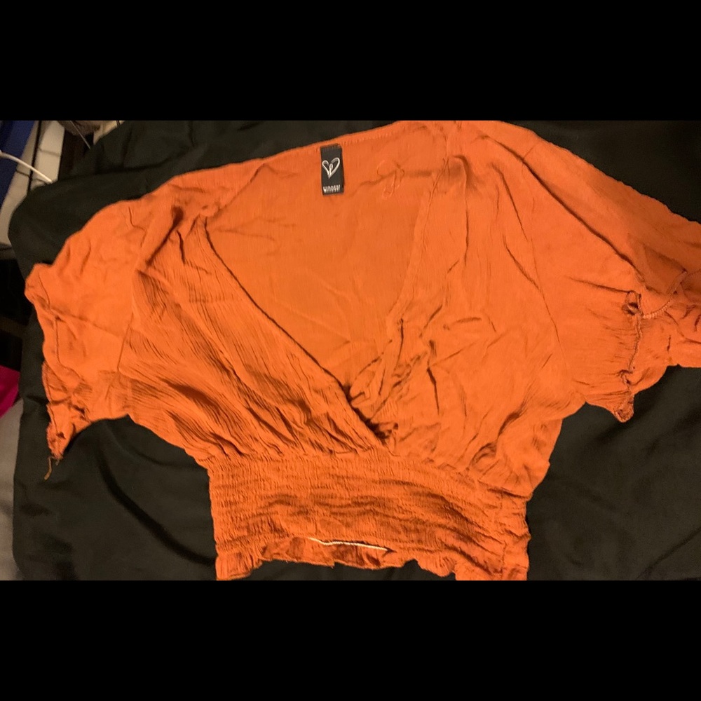 Flowy, low cut orange blouse